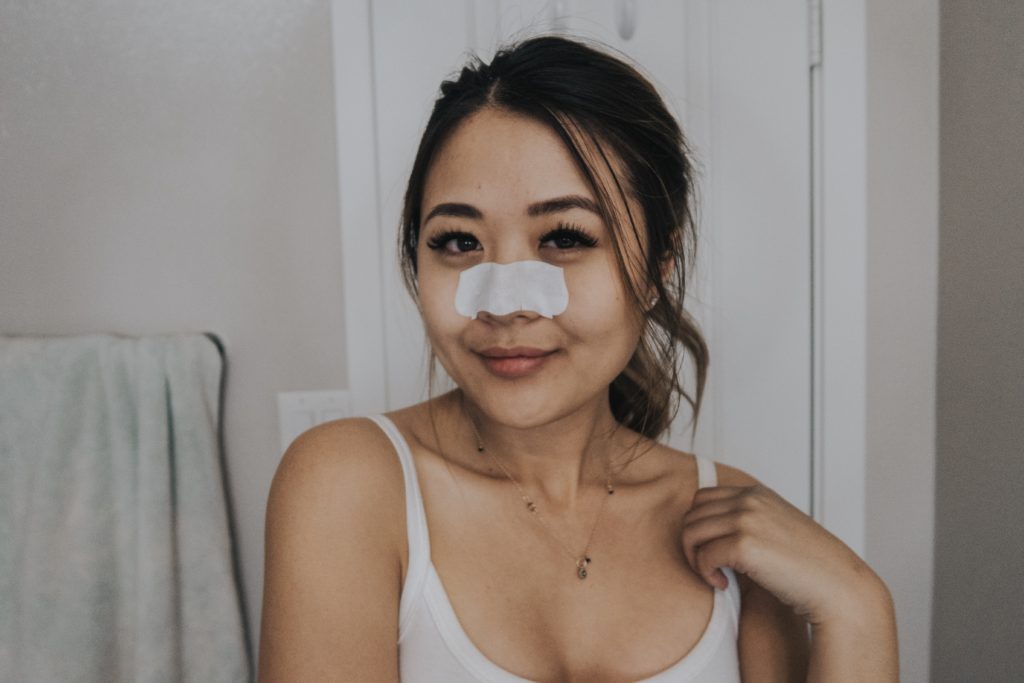 Lifestyle blogger Demi Bang using Biore Pore Strips.