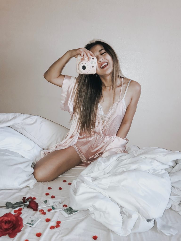 Arizona Lifestyle blogger Demi Bang talks about why she loves Valentine's Day while holding a Fujifilm Instax Polaroid. 
