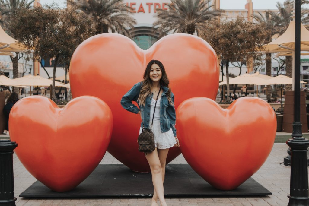Arizona lifestyle blogger, Demi Bang, at Westgate Entertainment in front of their hearts pop-up art installation.