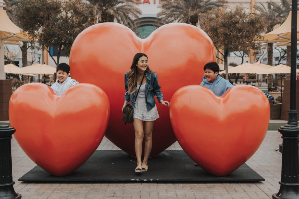 Arizona lifestyle blogger, Demi Bang, at Westgate Entertainment in front of their hearts pop-up art installation with her brothers. 
