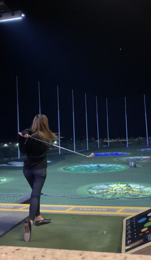 Demi Bang playing golf at TopGolf.