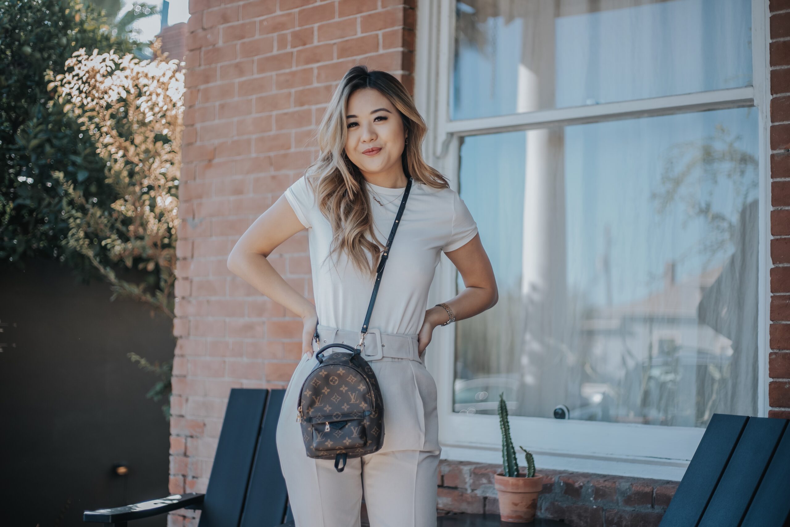 Demi Bang reviewing the Louis Vuitton Palm Springs PM backpack.
