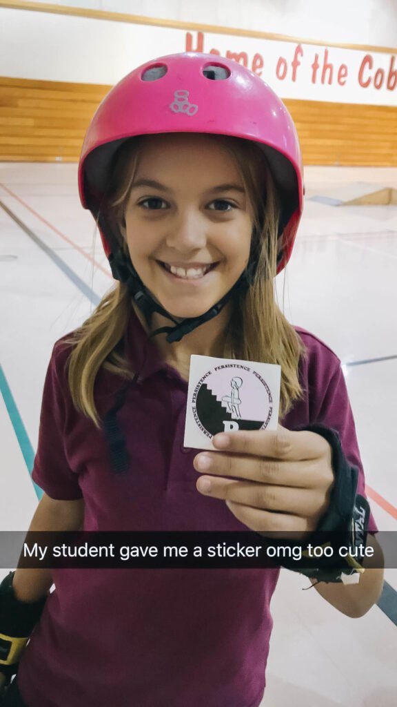 A student with Skate After School gave Demi Bang a sticker. 