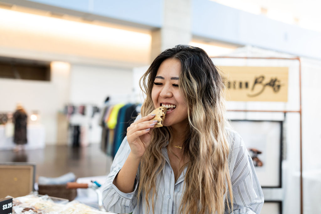 Demi Bang, an Arizona influencer, eating a cookie by The Modern Betty.