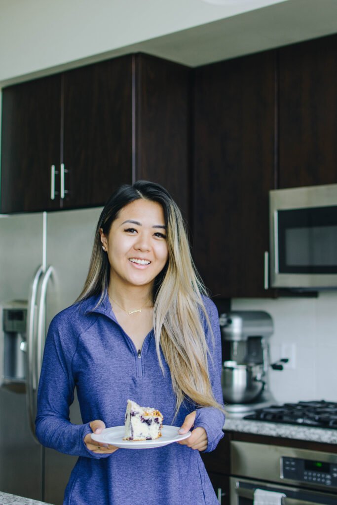 Demi Bang, an Arizona lifestyle blogger, holding a lemon blueberry coffee cake that she baked.