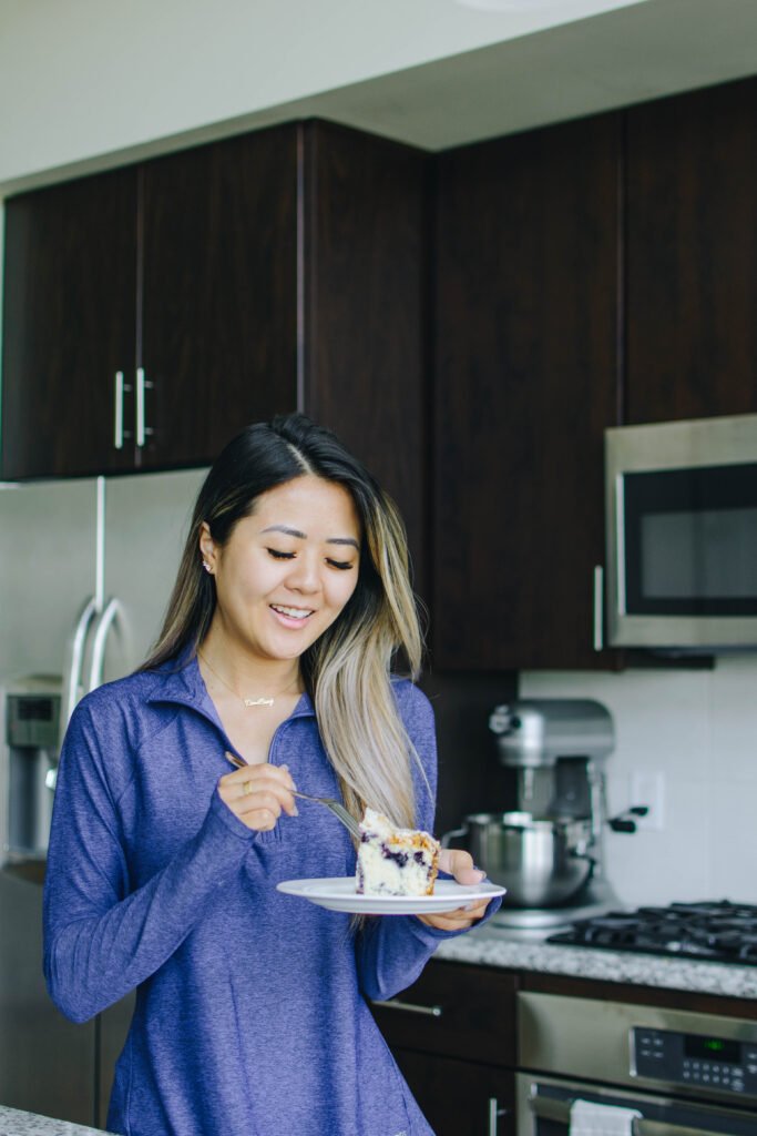 Demi Bang, an Arizona lifestyle blogger, eating a lemon blueberry coffee cake that she baked.