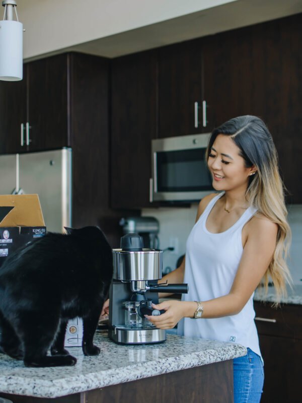 Demi Bang and her cat, Henry, looking at kitchen appliances from The Home Depot.