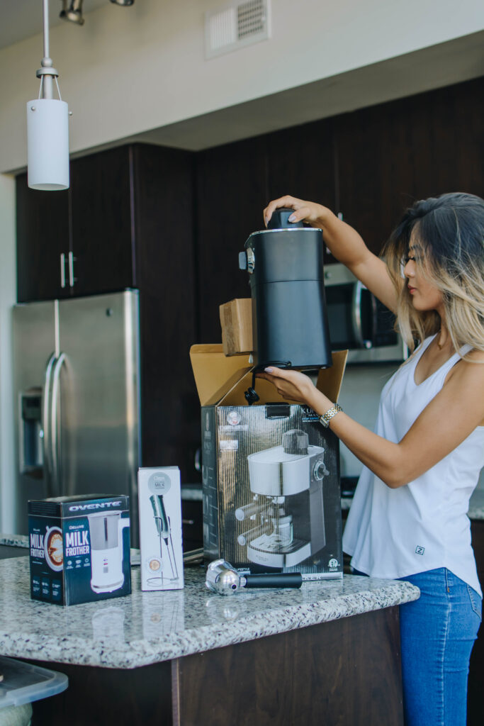 Demi Bang, Arizona blogger, opening up kitchen appliances from The Home Depot.