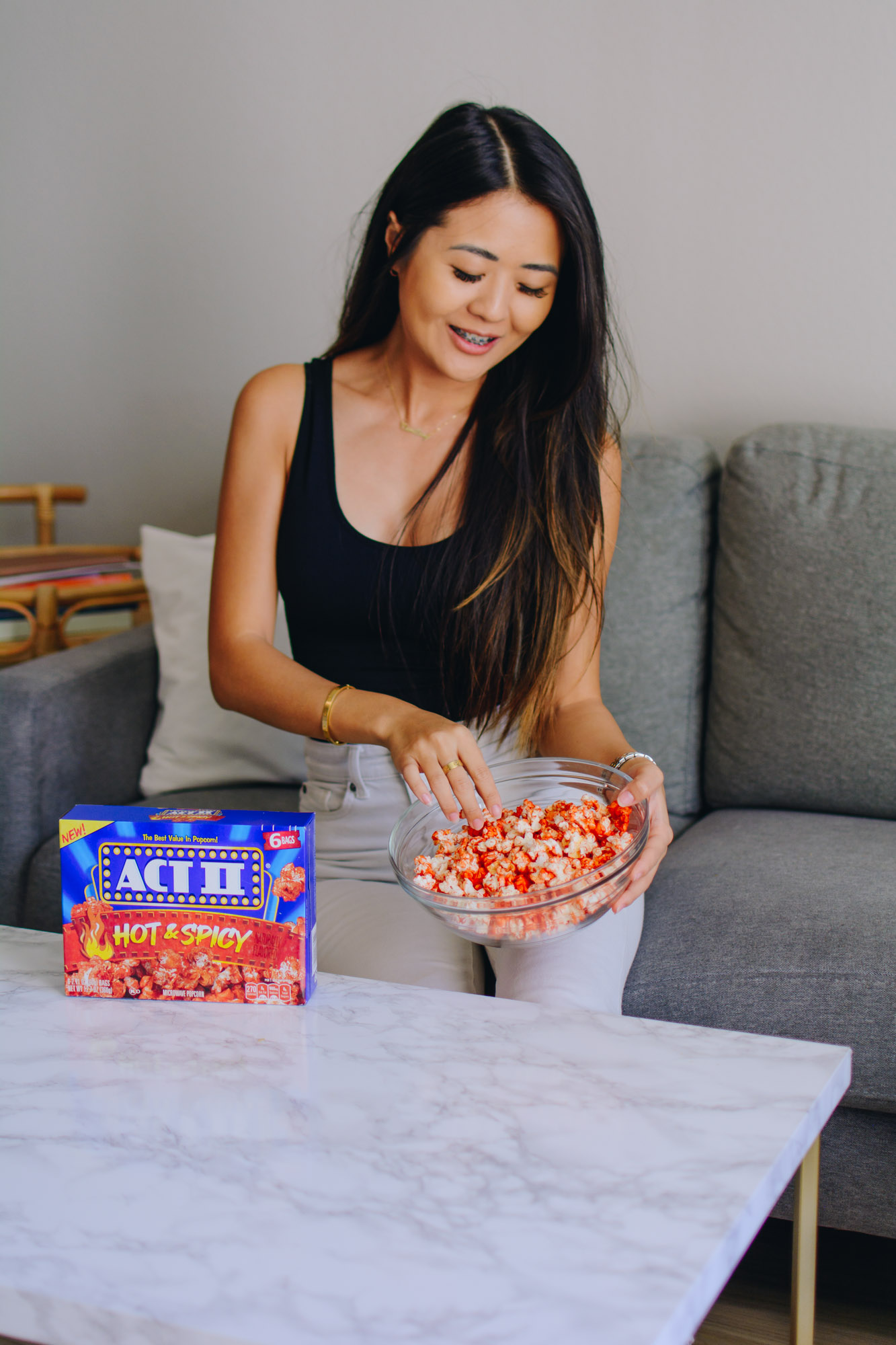 Lifestyle blogger Demi Bang tries Act II Spicy Popcorn for homegating.