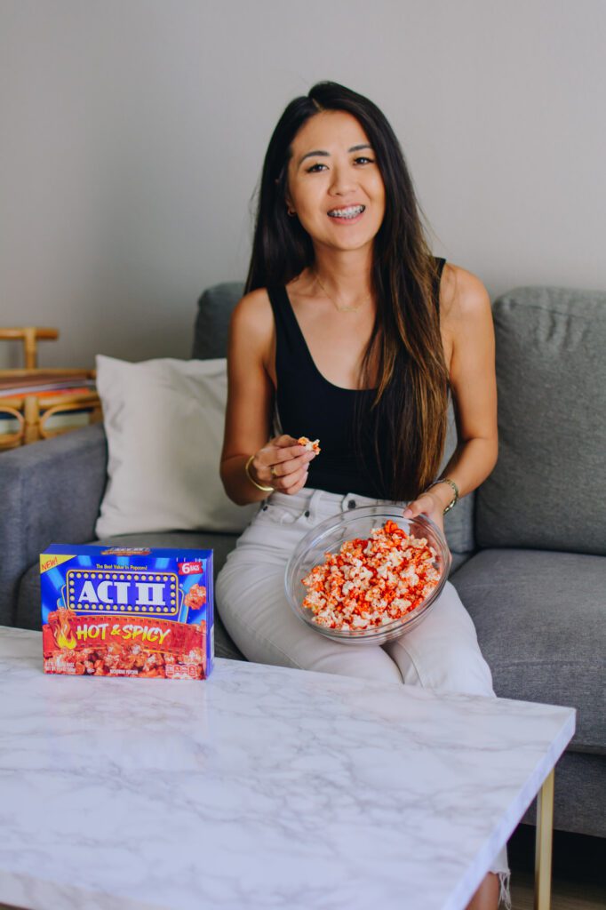 Arizona influencer Demi Bang tries snacks for homegating: Act II Spicy Popcorn. 
