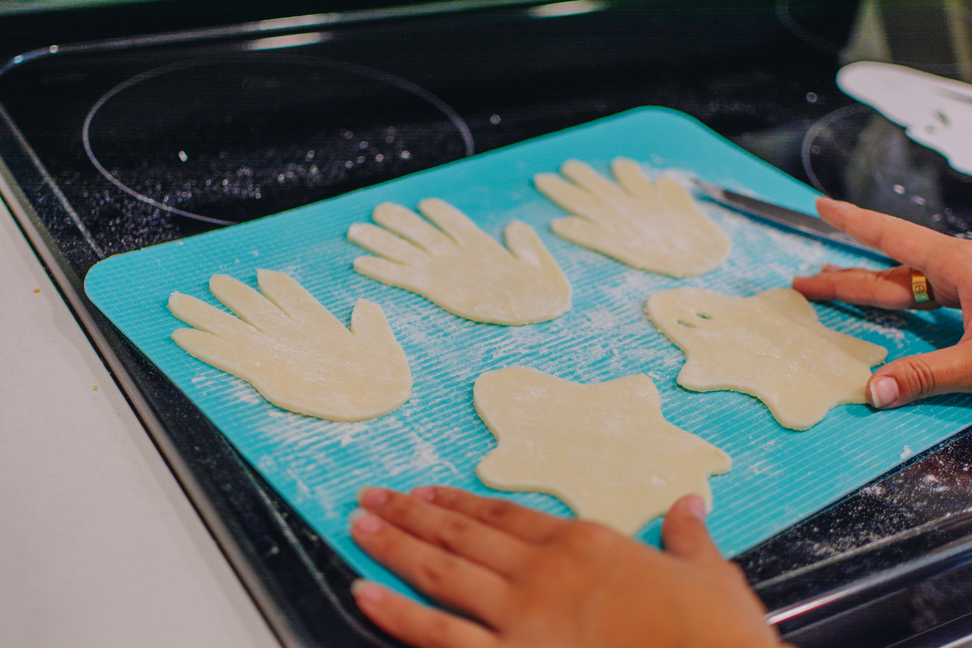 Blogger Demi Bang making Halloween pastries featuring a ghost and bloody hands.