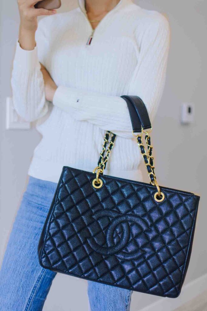 Wearing the Chanel Grand Shopping Tote on the elbow.