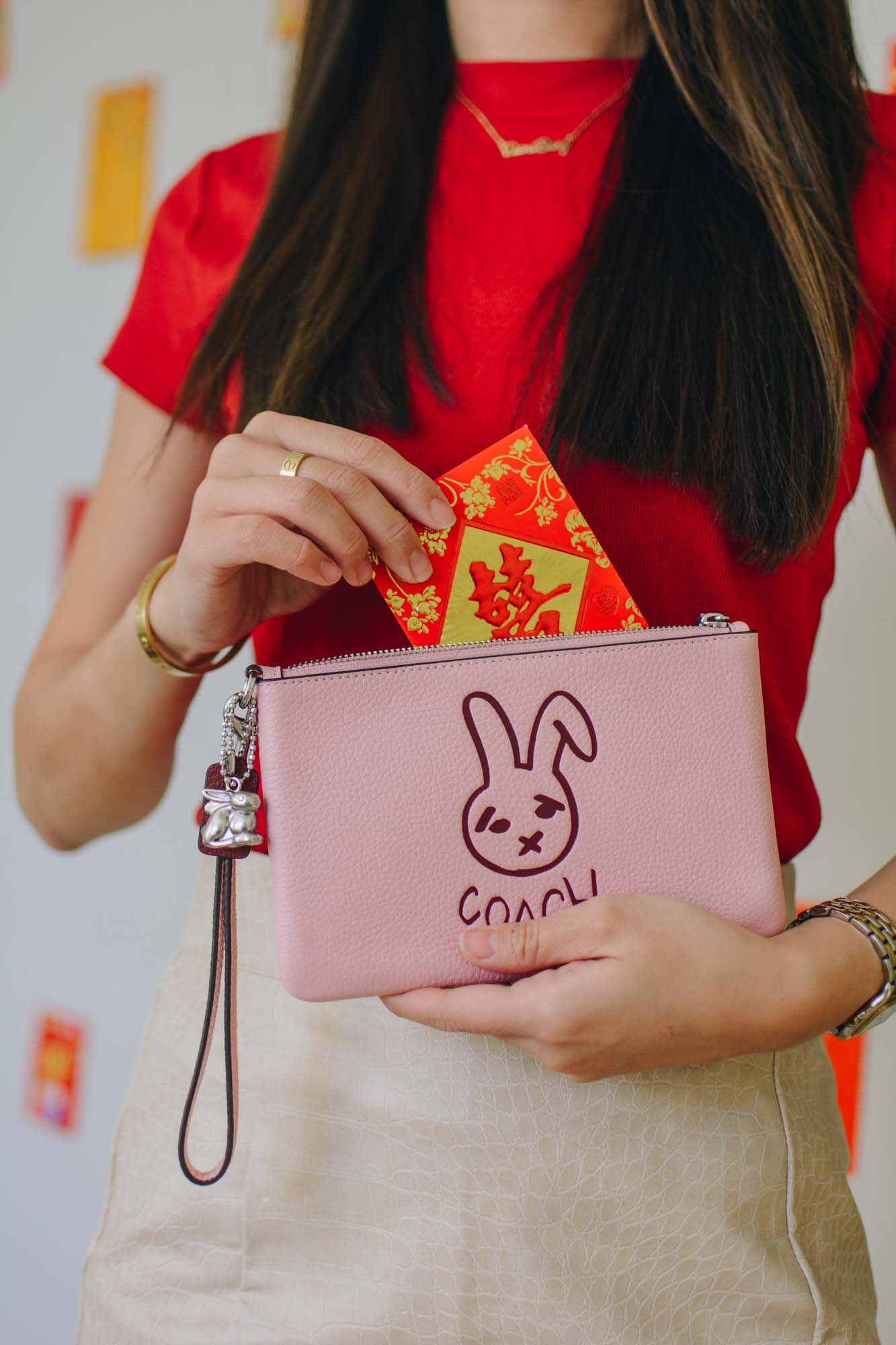 Demi Bang gives a limited-edition Coach Small Wristlet With Rabbit. 