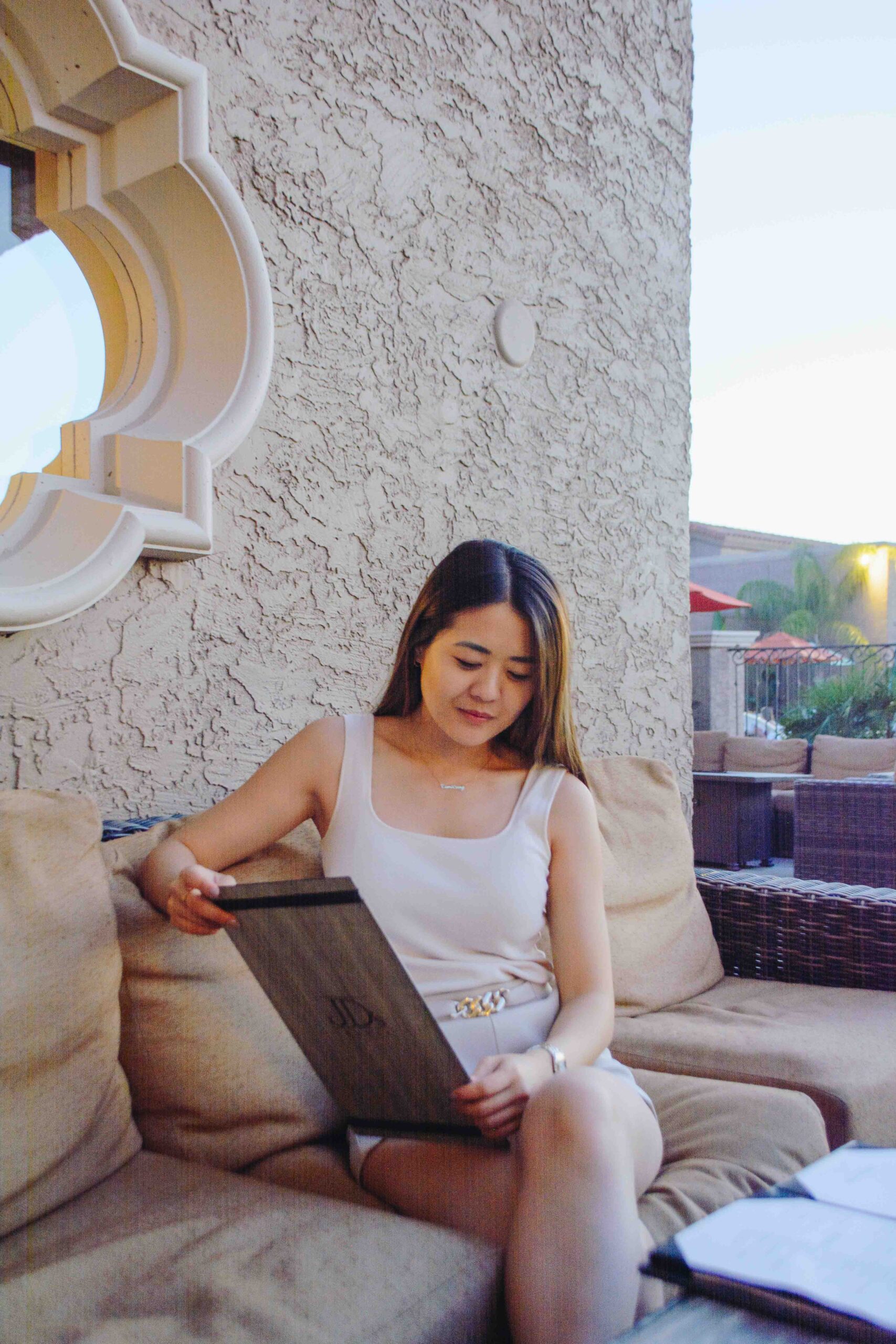 Arizona blogger Demi Bang reading the menu at JD's Restaurant and Lounge.