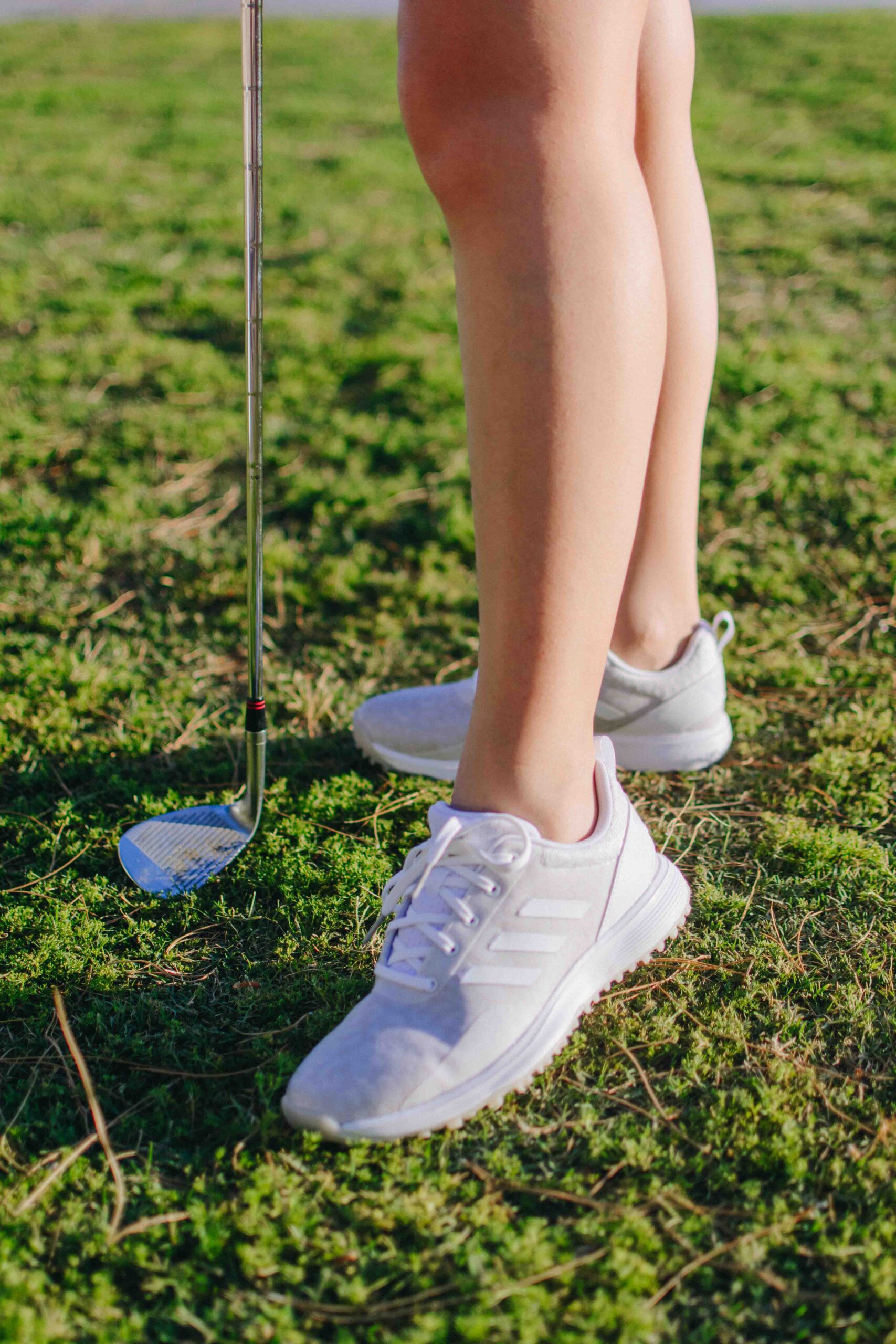 Demi Bang wearing adidas golfing shoes for women.
